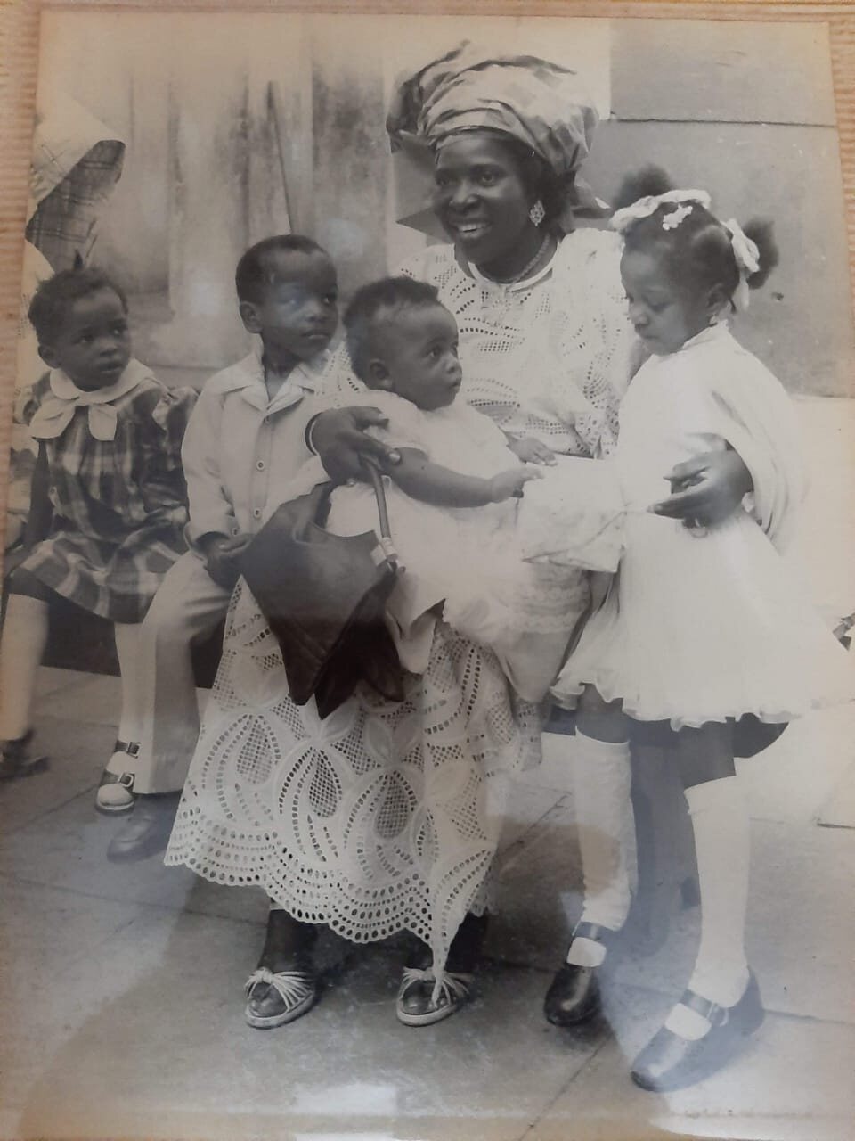 Margaret surrounded by children in an archival family photograph